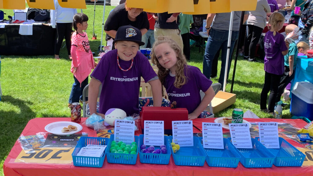 Two kids are selling infinity stones in a kid business fair
